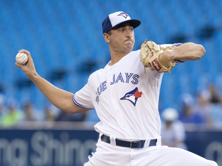Toronto Blue Jays starting pitcher Jacob Waguespack throws to a Seattle Mariners batter during the first inning of a baseball game Friday, Aug. 16, 2019, in Toronto.