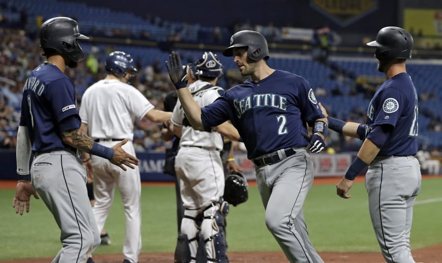 Seattle Mariners' Tom Murphy (2) celebrates with J.P. Crawford (3) and Austin Nola (23) after Murphy hit a three-run home run off Tampa Bay Rays starting pitcher Brendan McKay during the first inning of a baseball game, Monday, Aug. 19, 2019, in St. Petersburg, Fla.