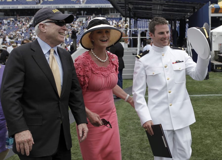 FILE - In this Friday, May 22, 2009, file photo, Sen. John McCain, R-Ariz., left, and his wife, Cindy, walk with their son Jack after he graduated from the U.S. Naval Academy in Annapolis, Md. The family of the late Sen. John McCain says they want to build a library on land donated by Arizona State University to house his archives and provide a “gathering place” for respectful dialogue.