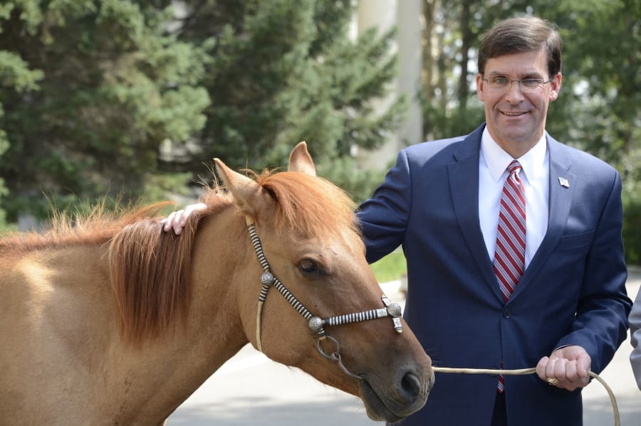 U.S. Defense Secretary Mark Esper poses with a horse presented as a gift at the Defense Ministry in Ulaanbaatar, Mongolia Thursday, Aug. 8, 2019. Esper’s stop in Ulaanbaatar — the third U.S. engagement with Mongolia in recent weeks, underscored its key role in America’s new defense strategy that lists China and Russia as priority competitors.