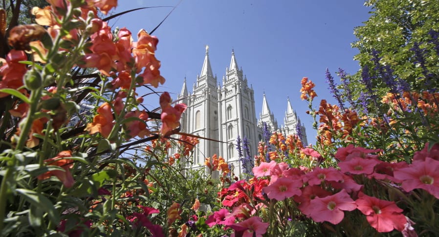 FILE - This Aug. 4, 2015 file photo, flowers bloom in front of the Salt Lake Temple, at Temple Square, in Salt Lake City. The Church of Jesus Christ of Latter-day Saints is reminding members that coffee is prohibited no matter how fancy the name, that vaping is banned despite the alluring flavors and that marijuana is outlawed unless prescribed by a competent doctor.