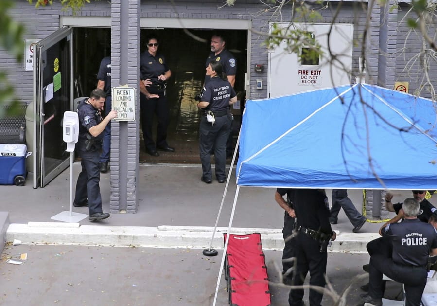 FILE - A Sept. 13, 2017 file photo shows a police staging area at the south entrance of the Rehabilitation Center at Hollywood Hills where residents died, in Hollywood, Fla.