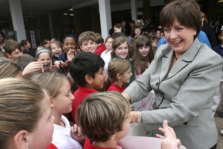 FILE- In this Nov. 6, 2007 file photo, Gov. Kathleen Babineaux Blanco is greeted by students of Maplewood Middle School in Sulphur, La. Blanco, who became Louisiana’s first female elected governor only to see her political career derailed by the devastation of Hurricane Katrina, died Sunday, Aug. 18, 2019. She was 76.
