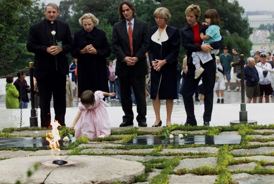FILE - In this June 6, 2000 file photo, Robert F. Kennedy’s granddaughter Saoirse Kennedy Hill places a white rose at the Eternal Flame, President John F. Kennedy’s gravesite, at Arlington National Cemetery in Arlington, Va. Hill, has died at the age of 22. The Kennedy family released a statement on Thursday night, Aug. 1, 2019, following reports of a death at the family’s compound in Hyannis Port, Massachusetts. Hill was the daughter of Robert and Ethel Kennedy’s fifth child, Courtney, and Paul Michael Hill.