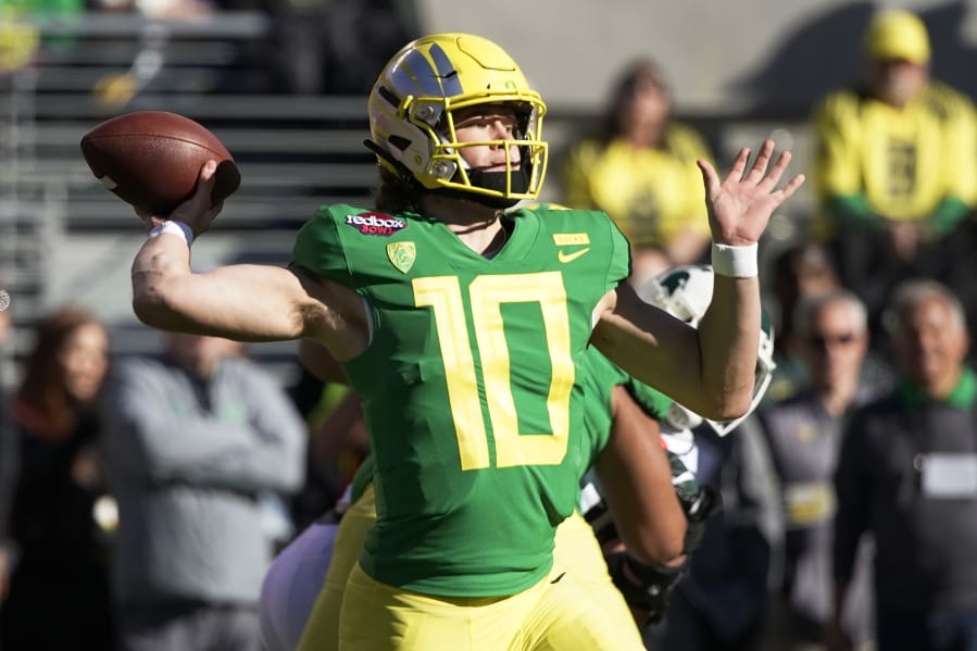 FILE - In this Dec. 31, 2018, file photo, Oregon quarterback Justin Herbert throws a pass during the first half of the Redbox Bowl NCAA college football game in Santa Clara, Calif. Herbert is among the top returning talents in the Pac-12, and the Ducks' hopes of league title contention in coach Mario Cristobal's second season could hinge on whether his quarterback improves on last year's 3,000-yard campaign.