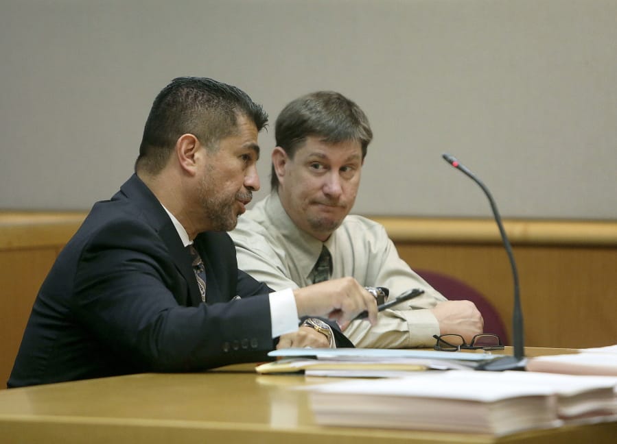 FILE - In an Oct. 19, 2018 file photo, attorney Bryant Camareno talks to his client defendant Michael Drejka during a pretrial hearing, at the Pinellas County Criminal Justice Center in Clearwater, Fla.