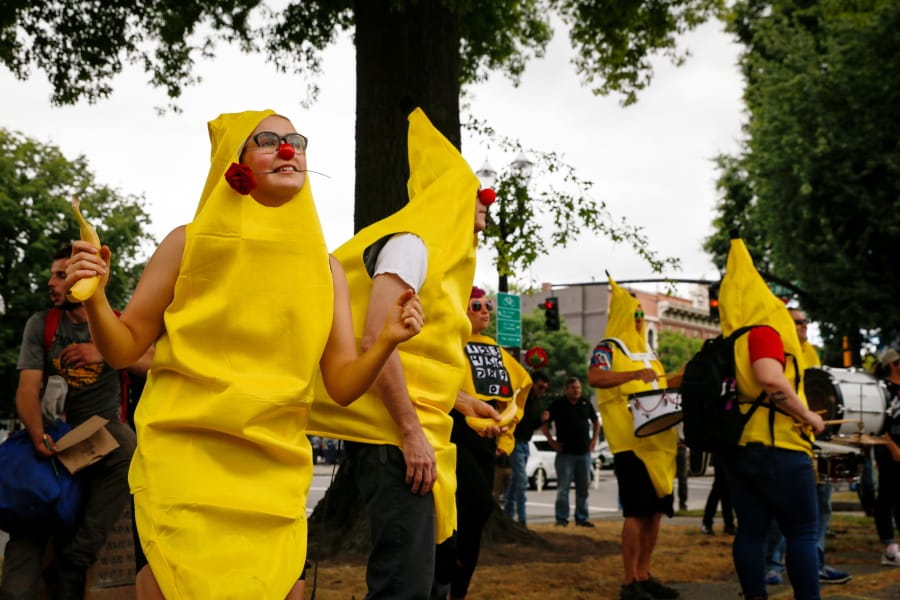 A “Banana Bloc Dance Party” gathering is held near Battleship Oregon Memorial Marine Park on Saturday, Aug. 17, 2019, in downtown Portland, Ore. Hundreds of far-right protesters and anti-fascist counter-demonstrators swarmed the downtown area, as police set up concrete barriers and closed streets and bridges in an effort to contain and separate the rival groups.