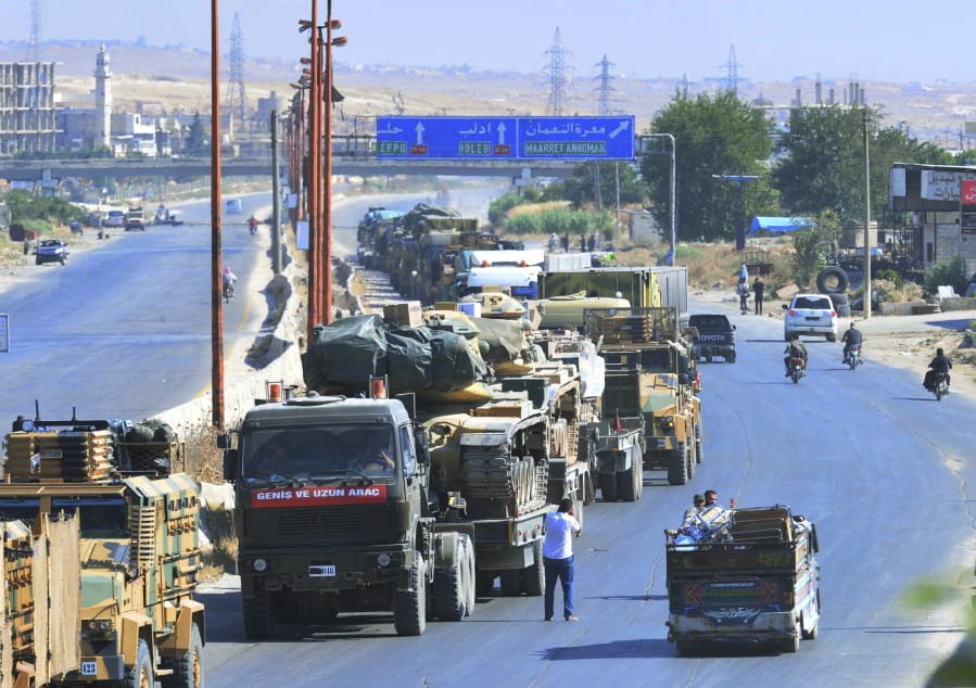 A Turkey Armed Forces convoy is seen at a highway between Maaret al-Numan and Khan Sheikhoun in Idlib province, Syria, Monday, Aug. 19, 2019. The Turkish Defense Ministry says airstrikes have targeted a Turkish military convoy in Syria, killing at least three civilians and wounding 12 others in Monday’s attack that occurred while the convoy was heading toward a Turkish observation post in the rebel-held stronghold of Idlib.