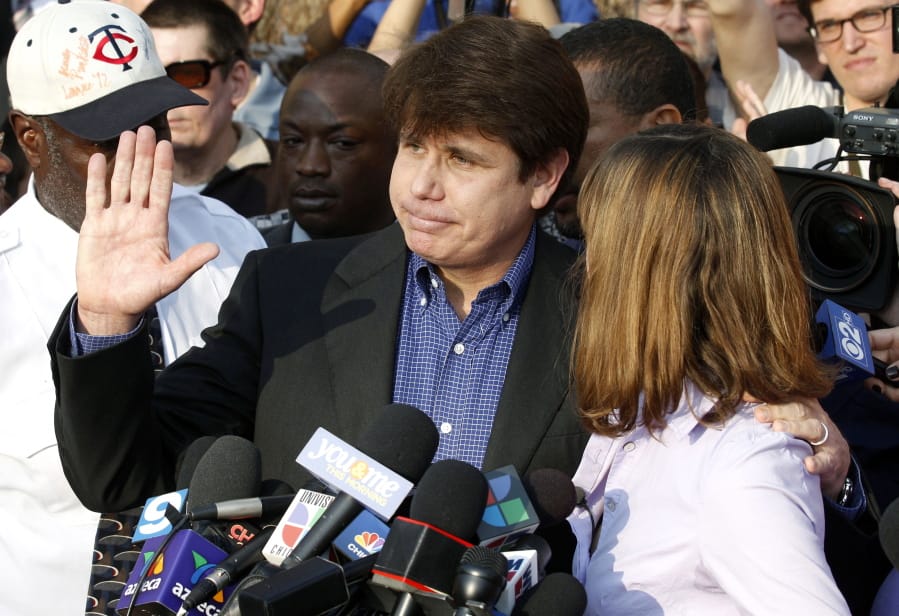 FILE - In this March 14, 2012, file photo, former Illinois Gov. Rod Blagojevich, with his wife Patti at his side, speaks to the media in Chicago before reporting to federal prison in Denver. President Donald Trump says he’s “very strongly” considering commuting the sentence of Blagojevich, who is serving a 14-year prison term on multiple federal corruption convictions. Trump suggested more than a year ago that he was considering a commutation for Blagojevich, who then filed paperwork requesting a commutation. (AP Photo/M.