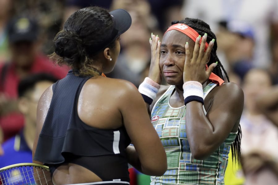 Coco Gauff wipes away tears while talking to Naomi Osaka, of Japan, after Osaka defeated Gauff during the third round of the U.S. Open tennis tournament Saturday, Aug. 31, 2019, in New York.