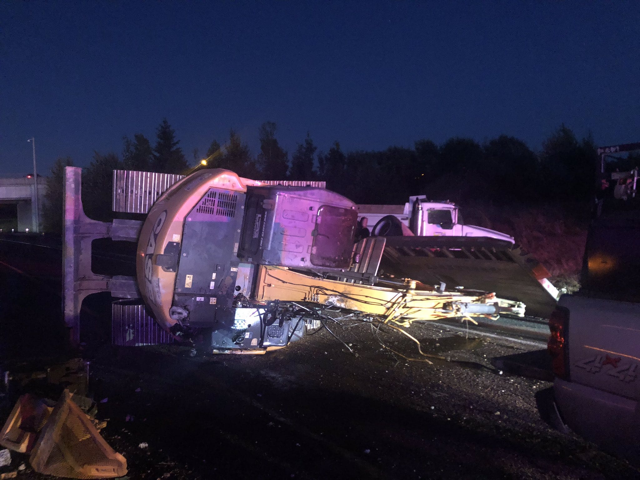 A tractor trailer hauling an excavator tipped over on the state Highway 502 onramp to southbound Interstate 5 in Ridgefield. The crash happened around 5:30 a.m., and the ramp remained blocked more than an hour later.