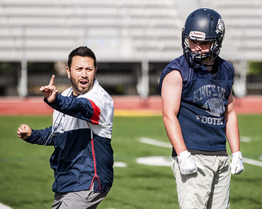 King’s Way Christian running back Connor Delamarter gets instruction from coach Brian Rodriguez.