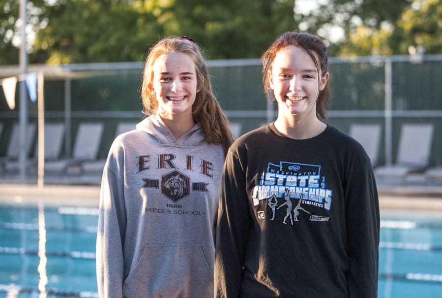 Camas senior Irelyne McGee, right, and junior Shealyne McGee stand by the pool at Cascade Athletic Club in Vancouver. The sisters make up two-thirds of the Camas dive team, which also includes junior Lili Ford.