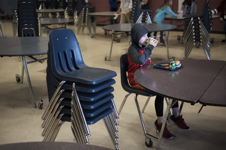 Fifth-grade student Daniel Casanova finishes his lunch in the mostly empty cafeteria of Chinook Elementary School in March after his fellow students left for recess. A state audit released last week found that elementary schools overwhelmingly are not providing children with enough time to eat their meals.