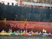 Protesters from the Mosquito Fleet paddled out from Kelley Point Park in Portland on Monday to the Port of Vancouver to protest a cargo ship they say is carrying pipe to be used for an expansion of the Trans Mountain Pipeline.