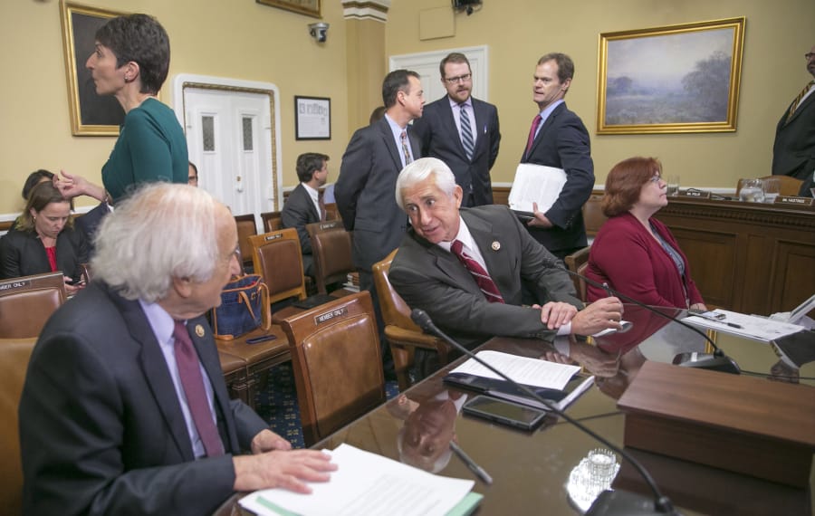 Sander Levin, from left, D-Mich., then the ranking member of the House Ways and Means Committee, confers with then-Rep. Dave Reichert, R-Wash., who was then a member of the committee, in December 2015 on Capitol Hill in Washington. Reichert, who did not seek re-election in 2018, may be eyeing a run for governor.