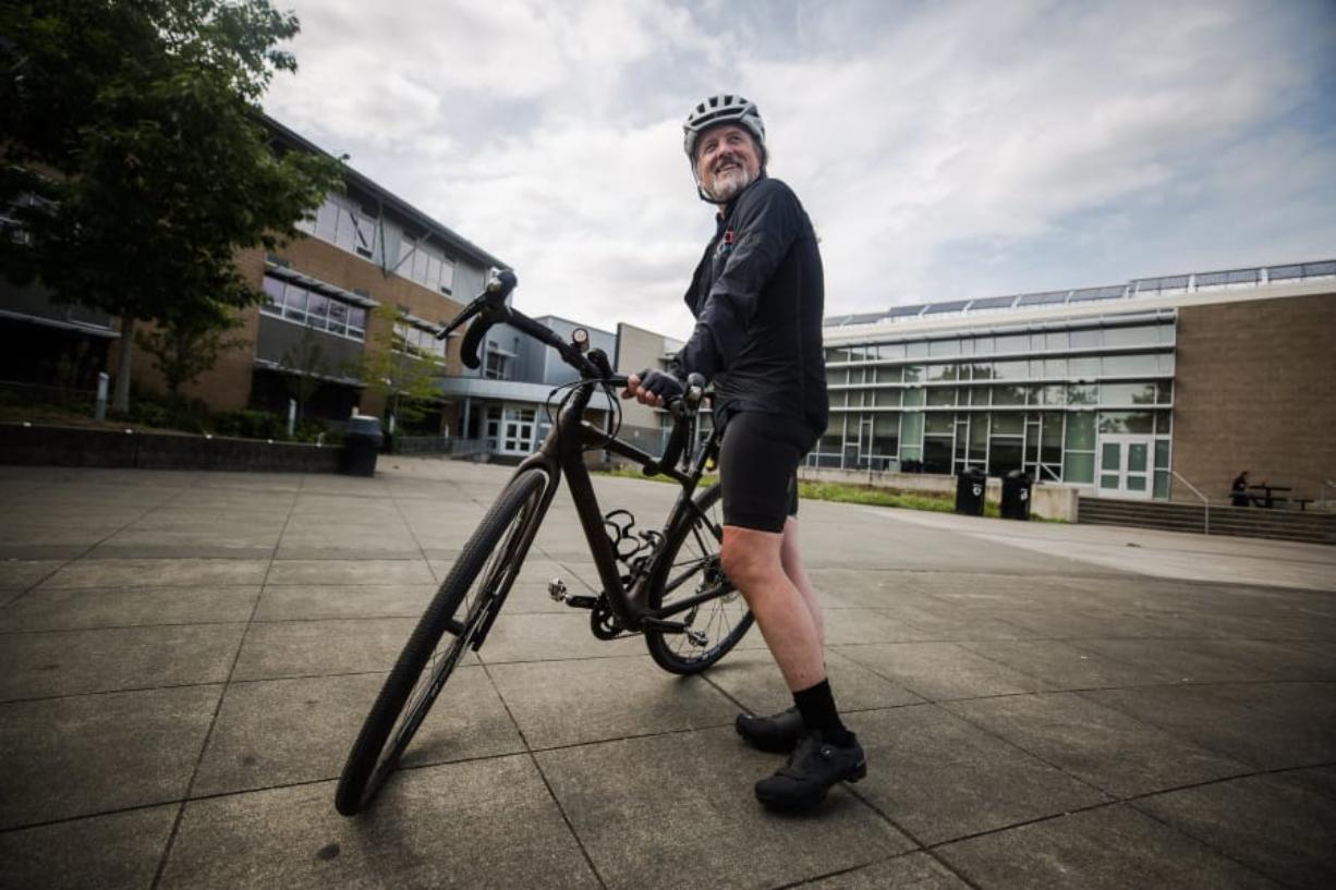 Robert Gay stands with his bike outside the Rainier Beach Community Center on Aug. 9. Gay, a novice cyclist, has partnered with Trips for Kids to raise awareness for the organization that provides bikes for kids in need, and is stopping along the way in cities with a chapter.