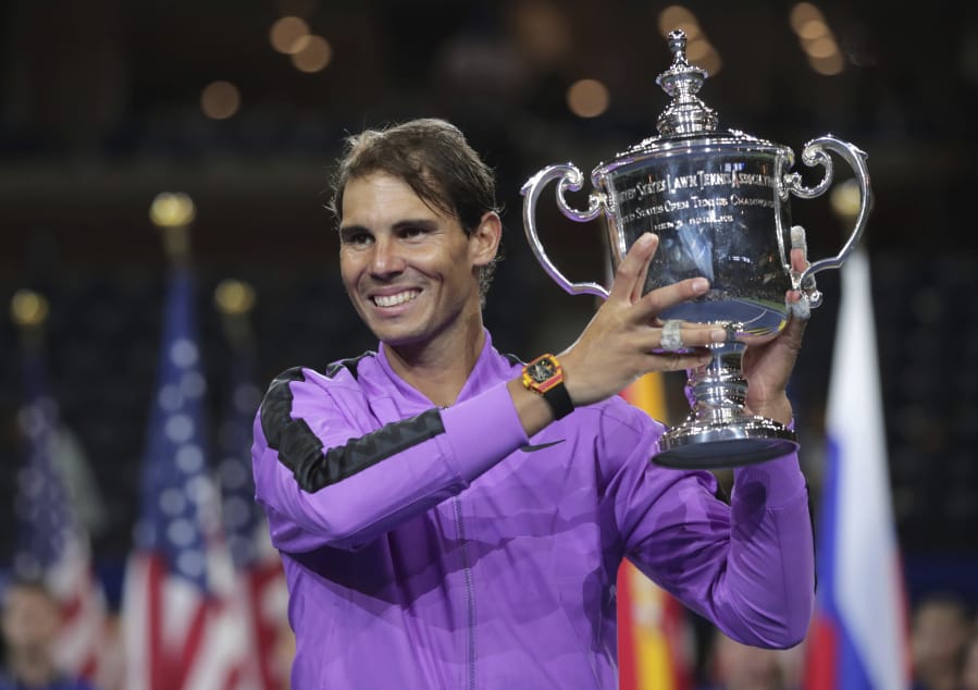 Rafael Nadal, of Spain, holds up the championship trophy after defeating Daniil Medvedev, of Russia, to win the men’s singles final of the U.S. Open tennis championships Sunday, Sept. 8, 2019, in New York.