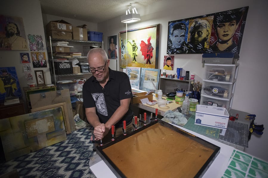 Chris Stevens, whose specialty is recycling pop culture and science fiction imagery with additional layers of strangeness and sparkle, builds a picture frame in his Salmon Creek studio.