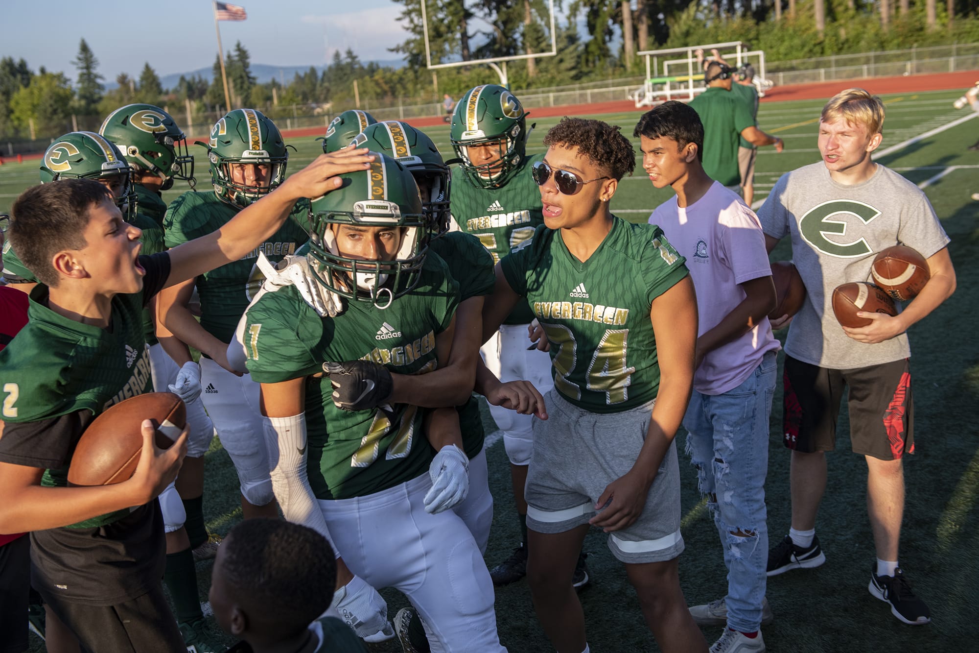 Evergreen’s Shane Newell (17) is congratulated by teammates after making a big play in the third quarter of the season opener at McKenzie Stadium in Vancouver on Friday evening, September 6, 2019.