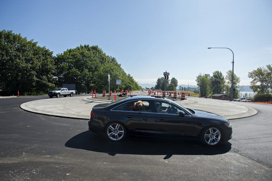 Drivers navigate the new roundabout at the intersection of state Highway 14 and Washougal River Road on Tuesday morning. Highway officials say the project is on schedule for completion later this year.