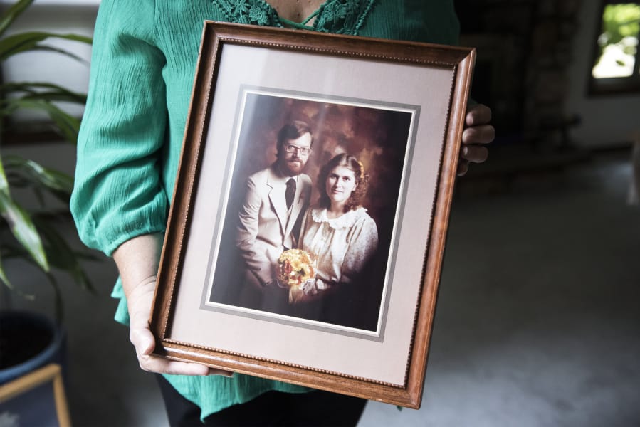 Fay Blackburn holds a photograph from her wedding to Reid Blackburn, a Columbian photographer who died while covering the 1980 Mount St. Helens eruption.