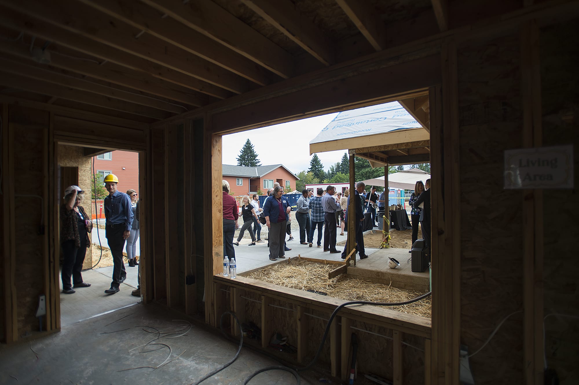 Visitors tour a first floor unit under construction at The Pacific Apartments as guests gather to celebrate the ongoing project, which will have 18 apartments for those dealing with homelessness, on Friday morning, Sept. 6, 2019.