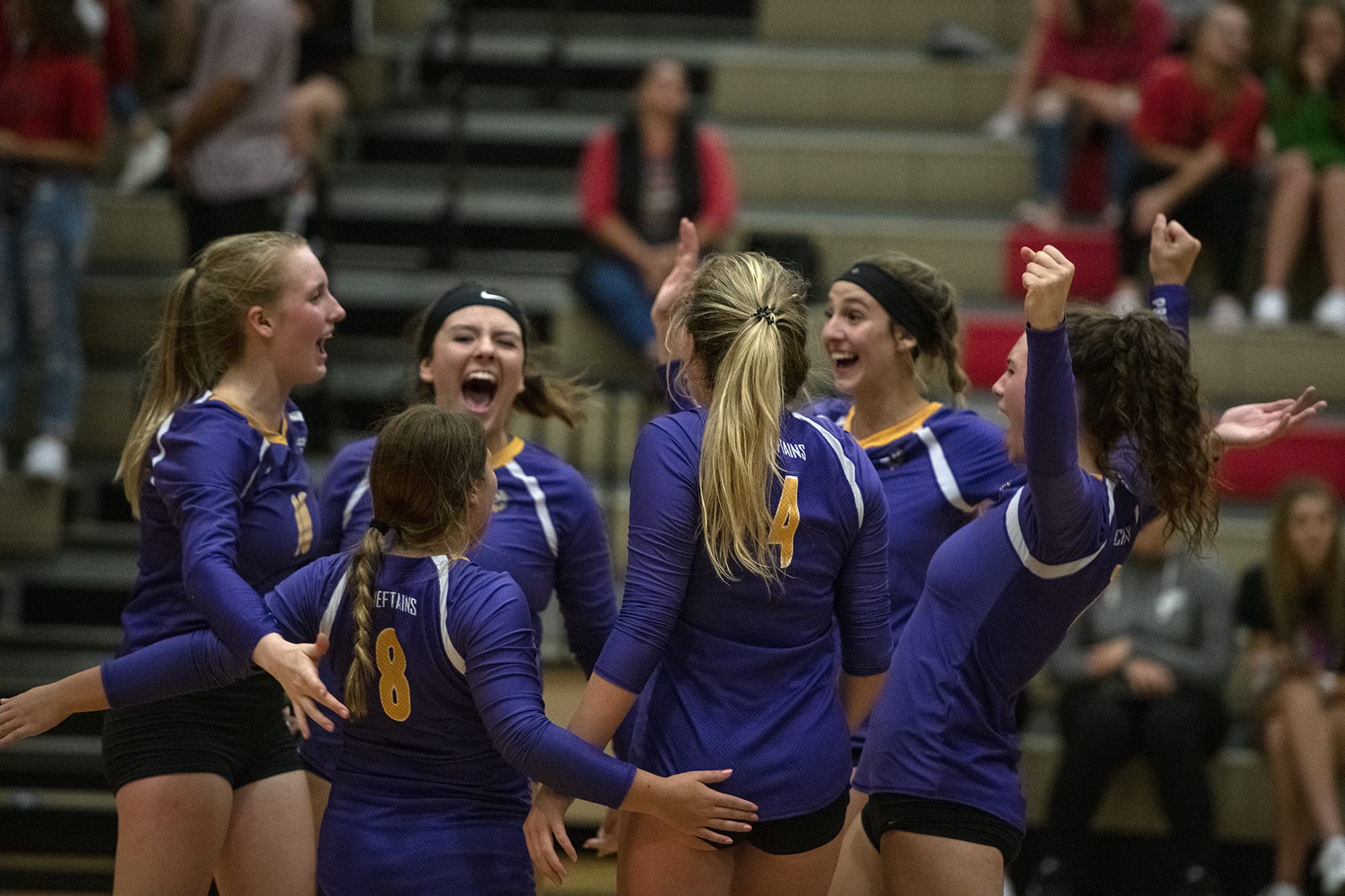 The Columbia River Chieftains celebrate a match point against the Camas Papermakers at Camas High School on Tuesday evening, September 10, 2019.
