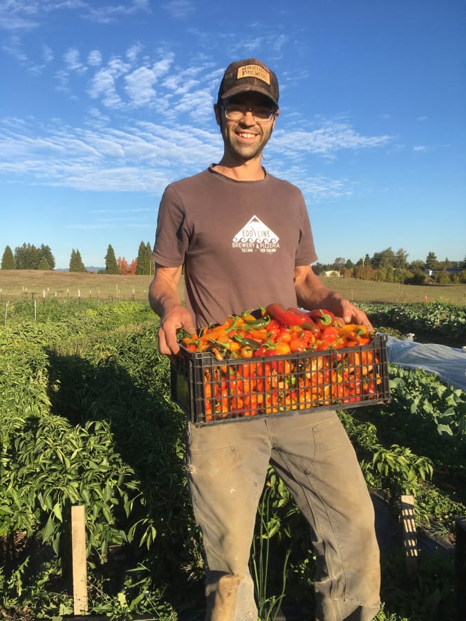 Co-owner Patrick Dorris showcases the bounty of Flat Tack Farms, which is hosting a farm-to-table dinner Sept. 21.
