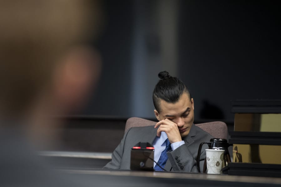 Mitchell Heng becomes emotional as he listens to audio recordings while taking the stand in his murder trial in Clark County Superior Court on Wednesday afternoon.