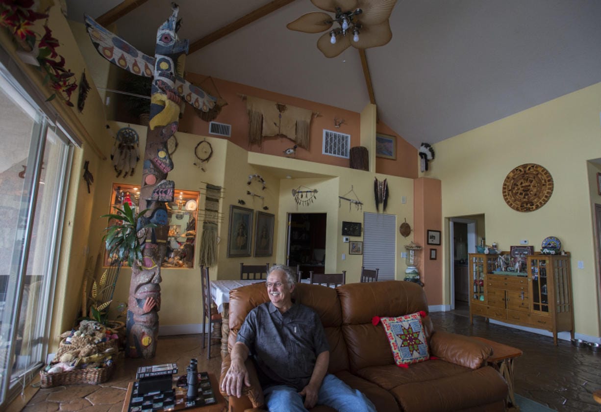 Woodland resident Bob Nelson pauses for a portrait in his home with one of the totem poles that used to be in the old Totem Pole Restaurant. The fate of the totem poles was the most popular question in The Columbian&#039;s latest round of &quot;Clark Asks,&quot; an online feature in which reporters directly answer reader questions.