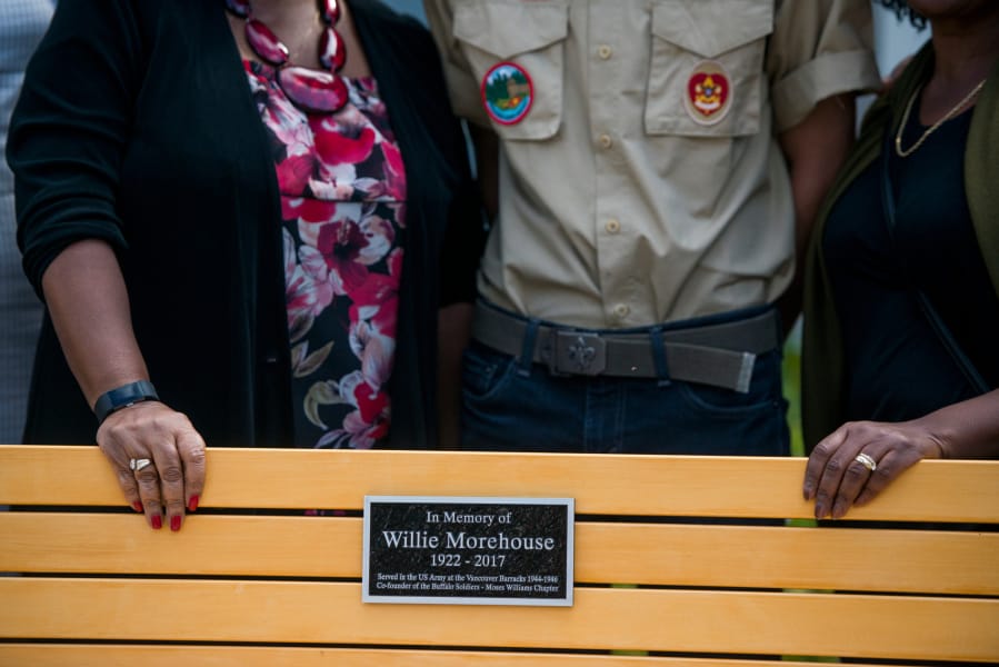 Wilson Keller, center stands for a picture with family members of Willie Morehouse behind a bench dedicated to him after a service for a new memorial for Buffalo Soldiers at the Fort Vancouver infantry barracks on Saturday, September 21, 2019. The memorial was the project of local Eagle Scout, Wilson Keller.