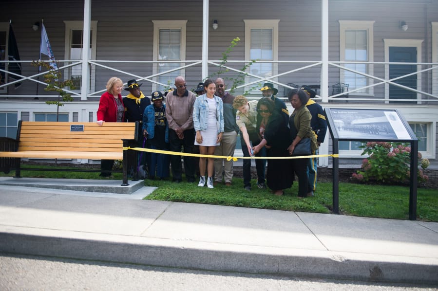 Wilson Keller cuts the ribbon for his Eagle Scout project with family members of Willie Morehouse, who served as a Buffalo Soldier, at the Fort Vancouver infantry barracks on Saturday, September 21, 2019. Keller's project was a memorial for Buffalo Soldiers who served in the American West.