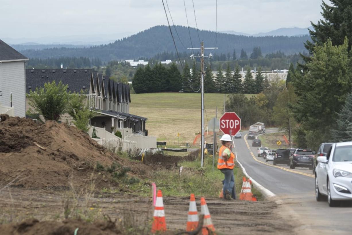 Flagger Hailey David monitors traffic as it drives past the construction site on Northwest Brady Road  in Camas on Monday.