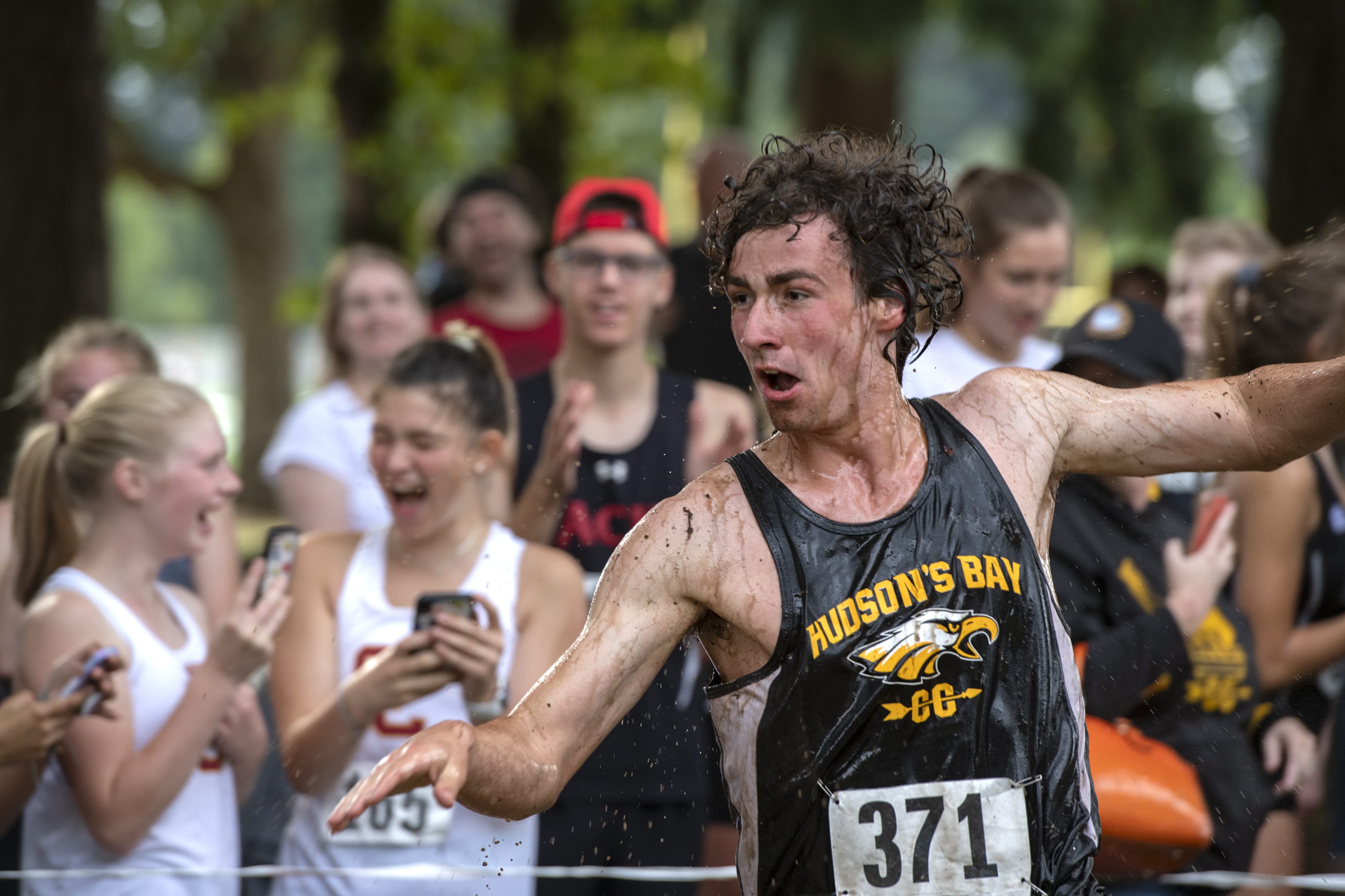 Hudson Bay's Brian Loop emerges from the water hazard during the Steve Maas Hudson's Bay Run-A-Ree cross country meet at Hudson's Bay High School on Friday afternoon, September 13, 2019.