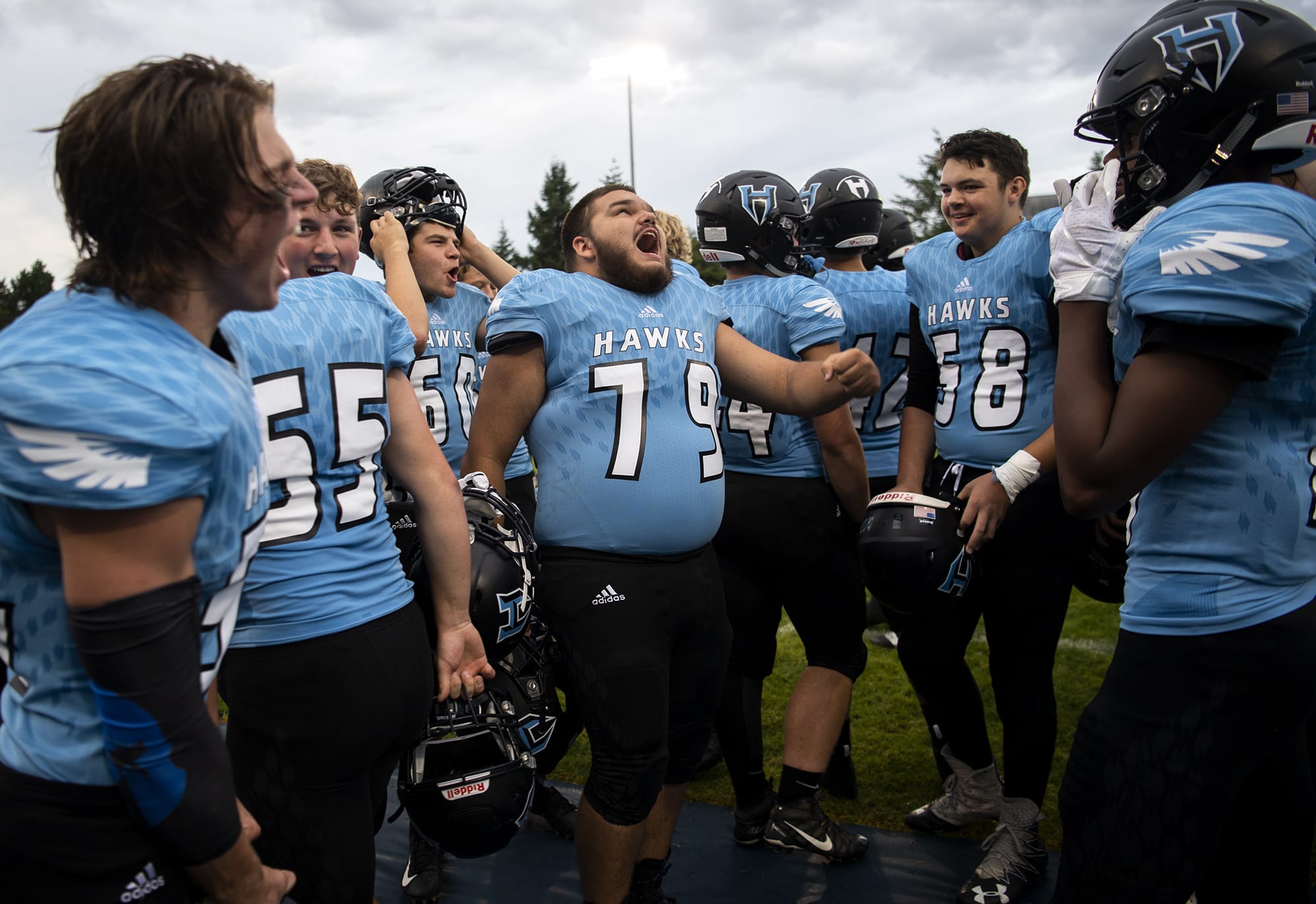 Hockinson players let our a roar before Friday nightÕs game in Hockinson on Sept. 13, 2019. The HawkÕs lost 21-27.