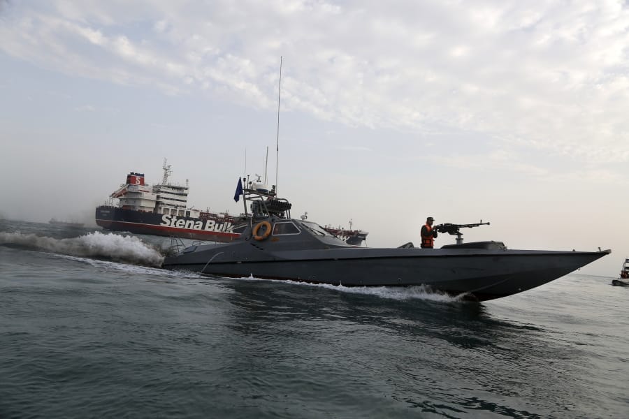 FILE- In this July 21, 2019 file photo, a speedboat of the Iran&#039;s Revolutionary Guard moves around a British-flagged oil tanker Stena Impero, which was seized on Friday by the Guard, in the Iranian port of Bandar Abbas. The assault on the beating heart of Saudi Arabia&#039;s vast oil empire follows a new and dangerous pattern that&#039;s emerged across the Persian Gulf this summer of precise attacks that leave few obvious clues of who launched them.