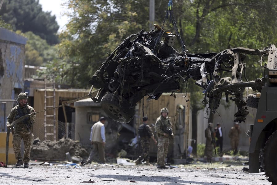 Resolute Support (RS) forces and Afghan security personnel clear debris at the site of a car bomb explosion in Kabul, Afghanistan, Thursday, Sept. 5, 2019. A car bomb rocked the Afghan capital on Thursday and smoke rose from a part of eastern Kabul near a neighborhood housing the U.S. Embassy, the NATO Resolute Support mission and other diplomatic missions.