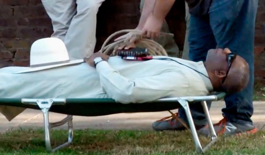 FILE - In this April 17, 2018, file image from video provided by KTHV-TV, a death penalty protester outside the Arkansas governor&#039;s mansion in Little Rock prepares to tie rope around Pulaski County Circuit Judge Wendell Griffen who is laying on a cot in protest of executions. Arkansas&#039; attorney general is asking the state Supreme Court to reassign cases involving her office from a judge who&#039;s been prohibited from handling execution cases, accusing him of regularly being biased against her staff. Attorney General Leslie Rutledge on Tuesday, Sept. 17, 2019, requested that the court reassign the civil cases from Pulaski County Circuit Judge Wendell Griffen, who was prohibited from handling execution cases in 2017 after he participated in an anti-death penalty demonstration.(KTHV/TEGNA Inc.