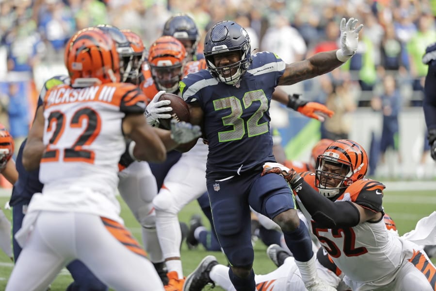 Seattle Seahawks running back Chris Carson (32) rushes against the Cincinnati Bengals during the second half of an NFL football game, Sunday, Sept. 8, 2019, in Seattle.