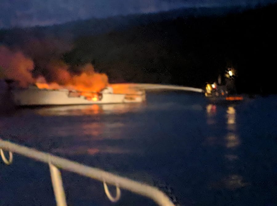 In this photo provided by the Santa Barbara County Fire Department, firefighters work to extinguish a dive boat engulfed in flames after a deadly fire broke out aboard the commercial scuba diving vessel off the Southern California Coast Monday morning, Sept. 2, 2019.