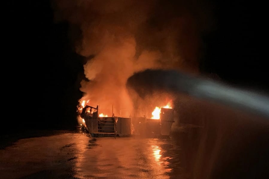 Ventura County Fire Department firefighters respond to a boat fire Sept. 2 off the coast of southern California. A crewman injured in the fire that killed 34 people aboard a dive boat off Southern California has sued the boat owner and the company that chartered the vessel.