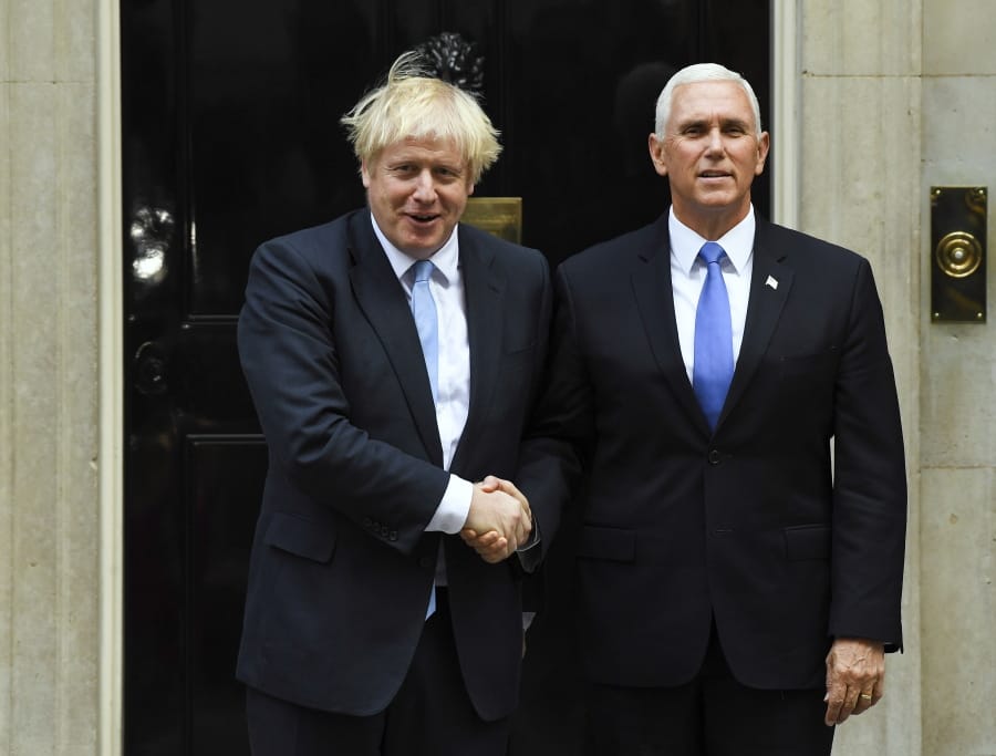 Britain’s Prime Minister Boris Johnson, left, greets U.S. Vice President Mike Pence on the doorstep of 10 Downing Street on Thursday in London.