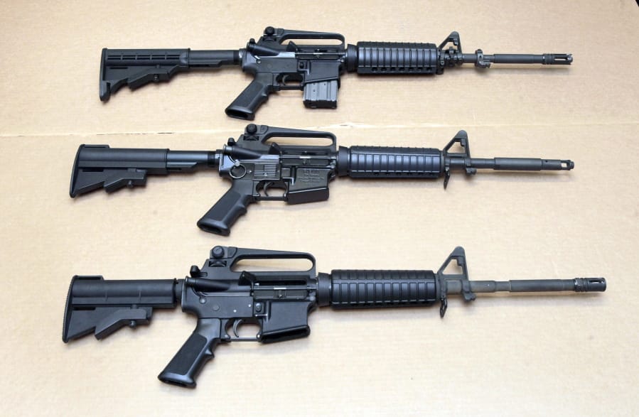 FILE - In this Aug. 15, 2012 file photo, three variations of the AR-15 rifle are displayed at the California Department of Justice in Sacramento, Calif. On Sept. 19, 2019, Connecticut-based Colt Firearms said it was suspending production of its version of the AR-15 for the civilian market.