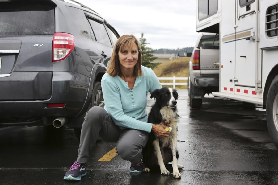 Carole King of Deer Park holds her border collie, Katie, on Tuesday. Katie went missing for 57 days before she was located in a Kalispell, Mont., neighborhood.
