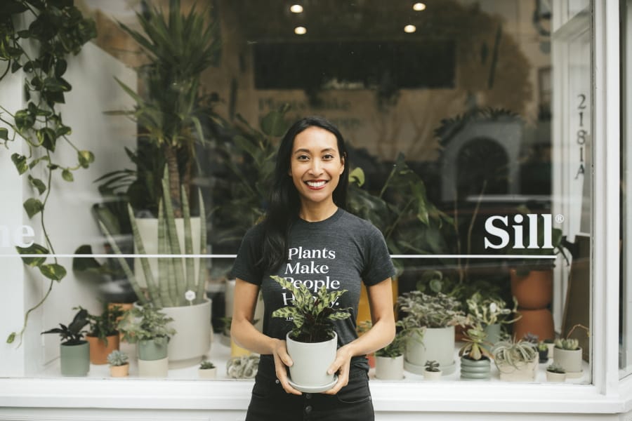 Eliza Blank from The Sill holds a Rattlesnake Calathea outside the shop in San Francisco. Blank is the founder and CEO of the popular gardening store and a plant influencer on Instagram.