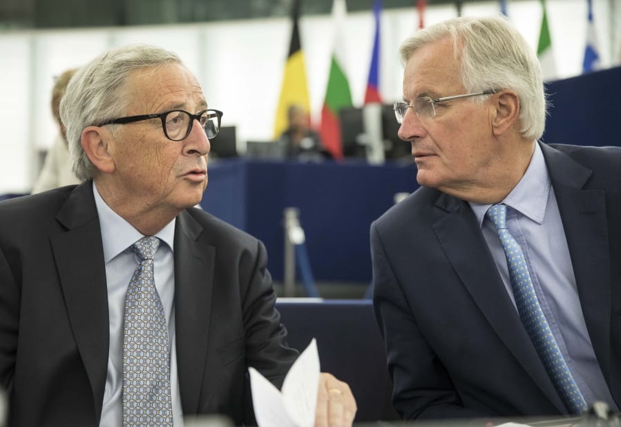 European Commission president Jean-Claude Juncker, left, speaks whith European Union chief Brexit negotiator Michel Barnier Wednesday, Sept. 18, 2019 at the European Parliament in Strasbourg, eastern France. The risk of Britain leaving the European Union without a divorce deal remains &quot;very real,&quot; European Commission chief Jean-Claude Juncker declared as EU lawmakers debated the ramifications of a no-deal Brexit.