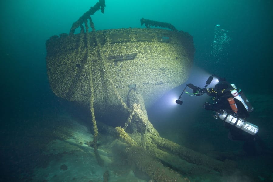 In this Aug. 24, 2019, photo provided by John Janzen, diver John Scoles maneuvers around the wreckage of the schooners Peshtigo and St. Andrews, lost in 1878 near Beaver Island in northern Lake Michigan. A group of maritime history enthusiasts led by Boyne City, Michigan diver and explorer, Bernie Hellstrom have announced the discovery of the schooners. The site was located in 2010 by Hellstrom during one of his many trips to explore the Beaver Island archipelago.