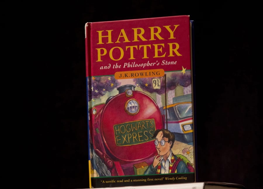 The first Harry Potter book “Harry Potter and the Philosopher’s Stone” is displayed at Sotheby’s auction house’s premises in London. A Catholic school in Tennessee has removed the Harry Potter books from its library.