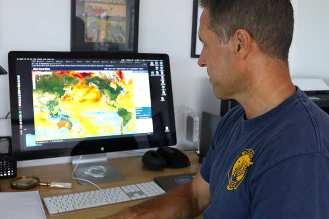 In this Sept. 13, 2019 photo, ecologist Greg Asner, the director of Arizona State University's Center for Global Discovery and Conservation Science, reviews ocean temperature data at his lab on the west coast of the Big Island near Captain Cook, Hawaii. "Nearly every species that we monitor has at least some bleaching," said Asner after a dive in Papa Bay.